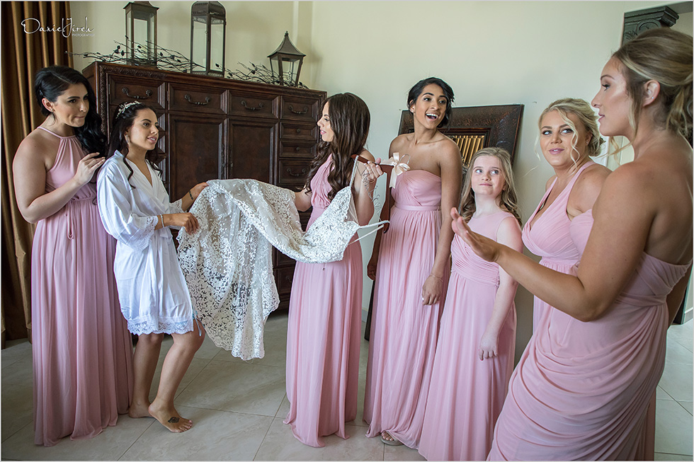 bride and bridesmaids with wedding dress