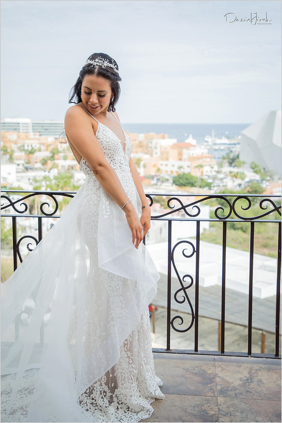 bride on balcony in wedding dress