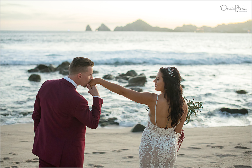 Groom kissing his bride on the beach